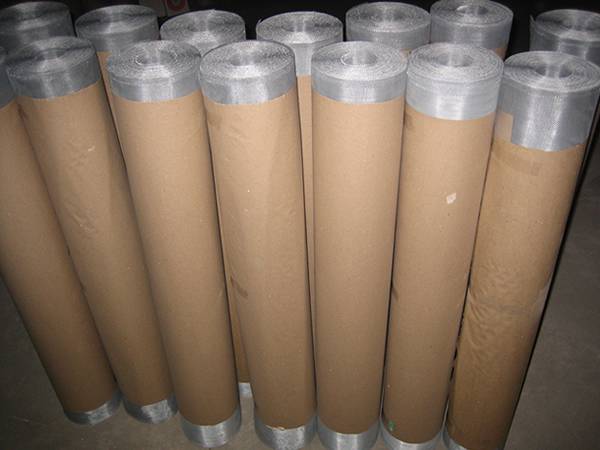 Bright aluminum mesh screen rolls are wrapped with waterproof paper in our warehouse