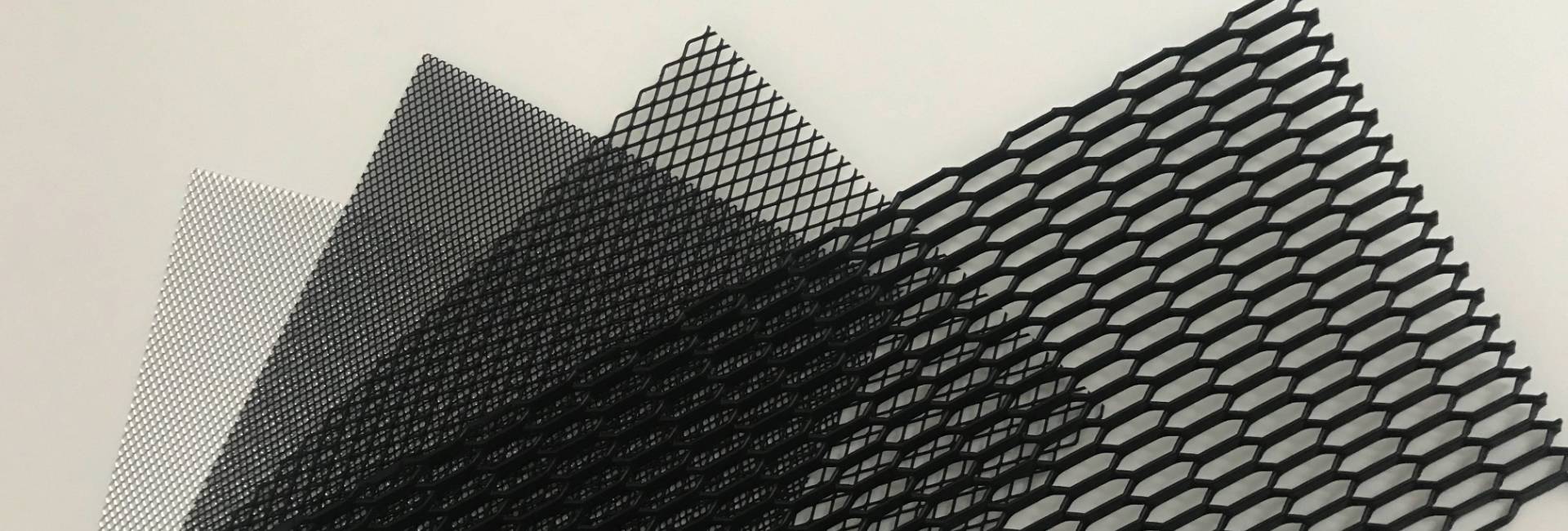 Four types of aluminum mesh car grill samples are displayed.