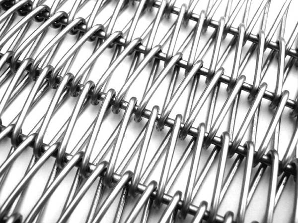 A piece of aluminum conveyor belt made from round spiral wire and curved round cross rod